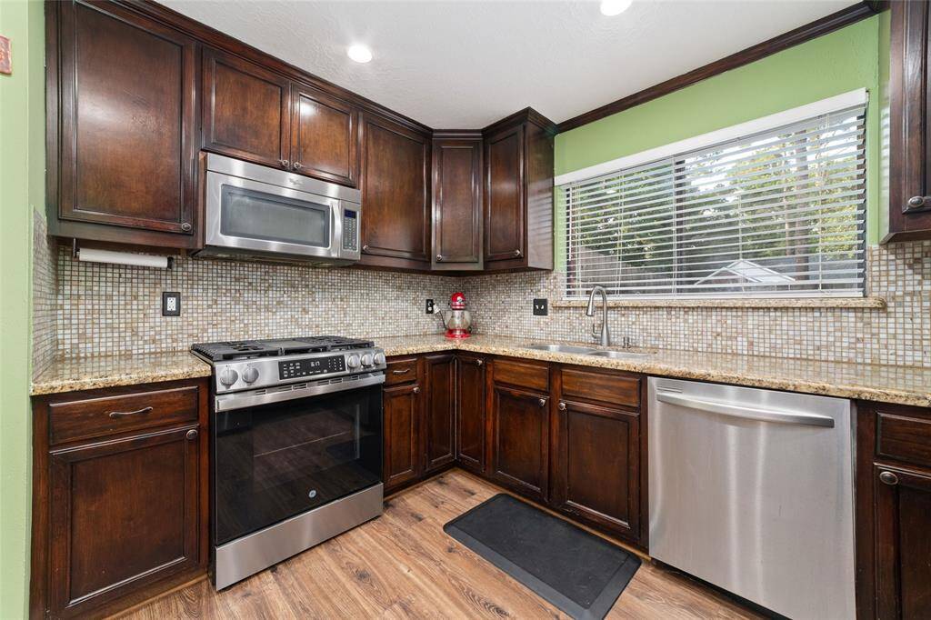 Stainless steel appliances, granite counters, and lots of storage, including a pantry. All appliances stay.