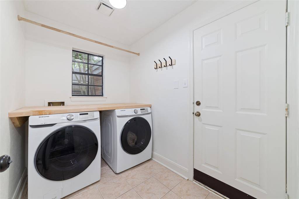 Spacious laundry room with folding table. The door leads to the 2-car garage with epoxy flooring!