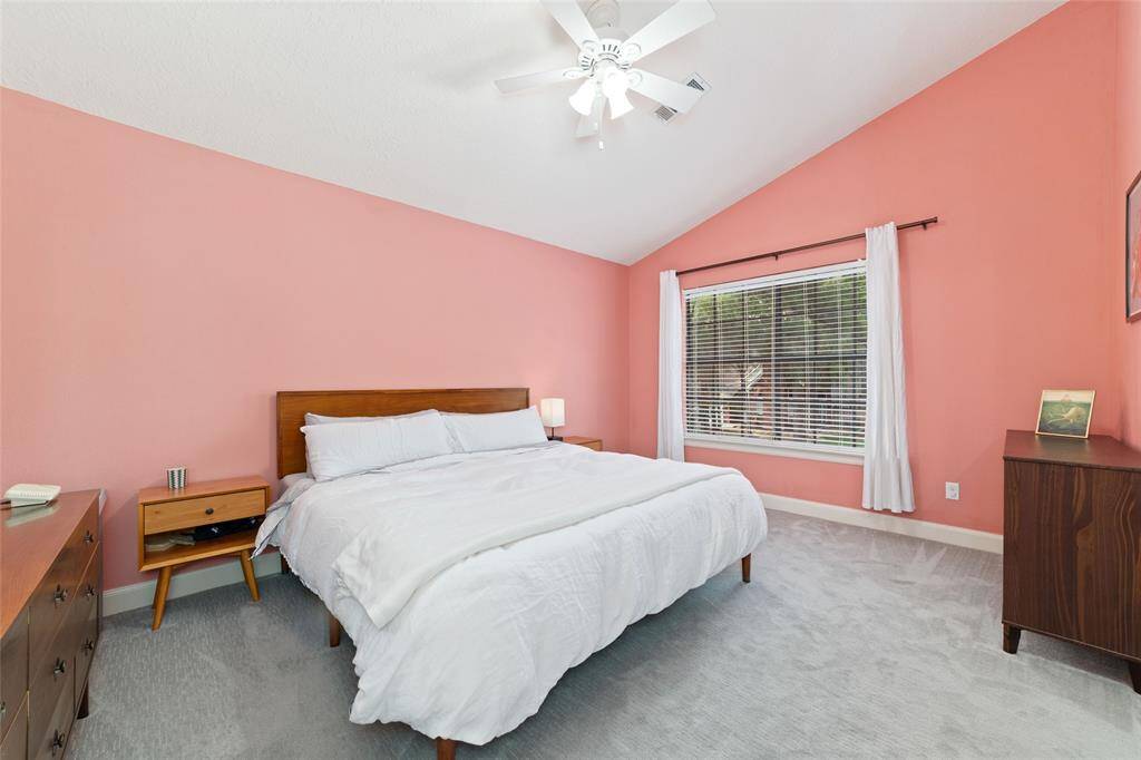 Large primary bedroom with an 11ft vaulted ceiling adding depth and space.