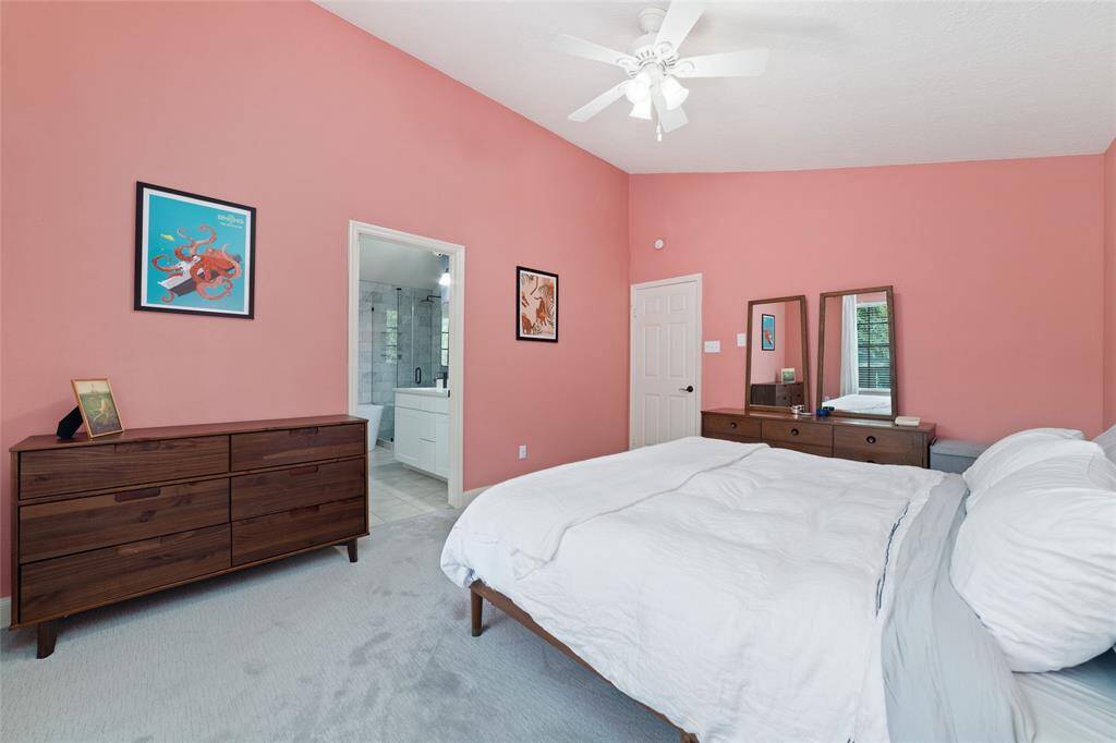 Primary bedroom leads to the remodeled en-suite bathroom and walk-in-closet.