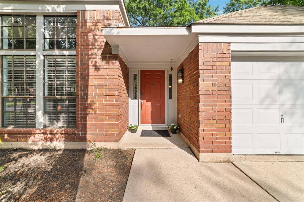 Wall of windows hint at what to expect once you step inside. Inviting covered front porch entry.
