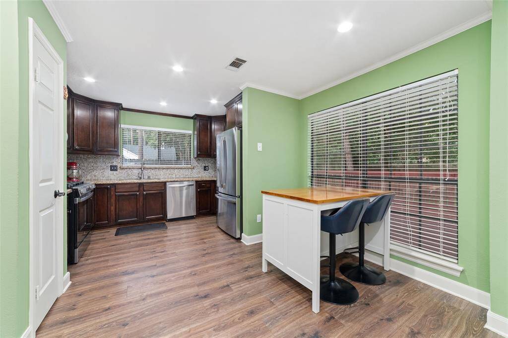 Kitchen with breakfast nook overlooks the private backyard.