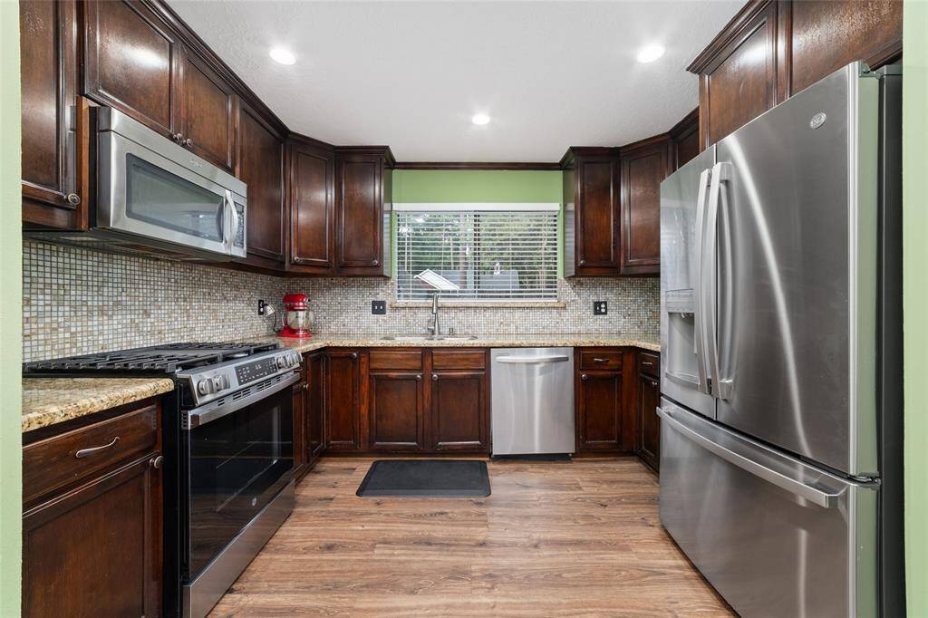 Stainless steel appliances, granite counters, and lots of storage, including a pantry. All appliances stay.
