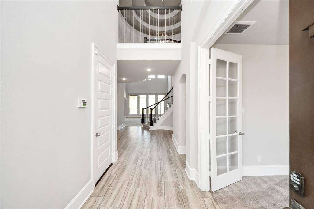 entry way with a private study on the right