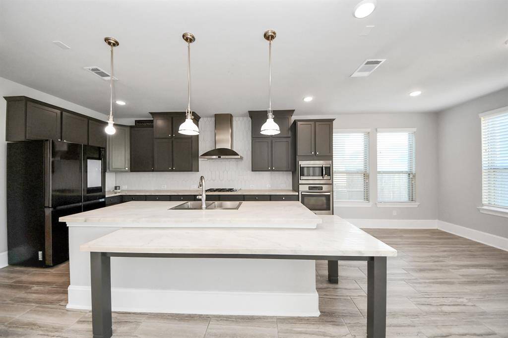 two-level kitchen bar with white double edge quartz countertop