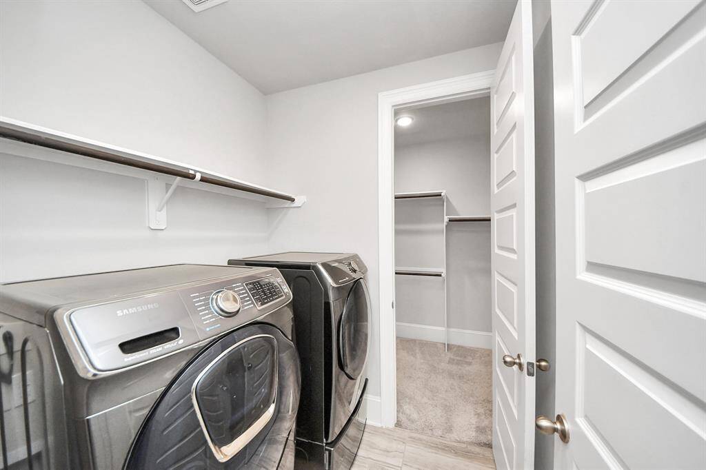 laundry room with samusung washer/dryer is included