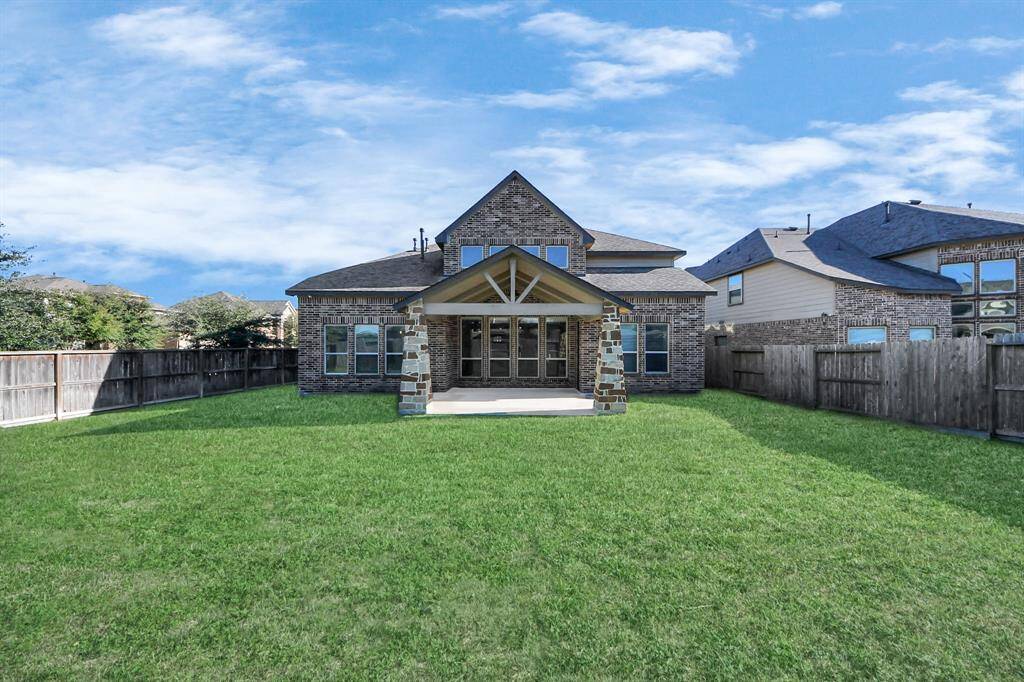 large backyard with extended covered patio