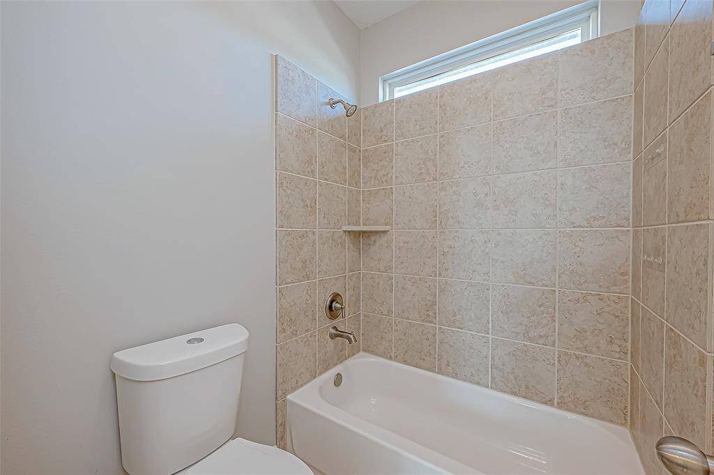 Featuring a toilet, bathtub, and shower for comfort and luxury in your dream home.