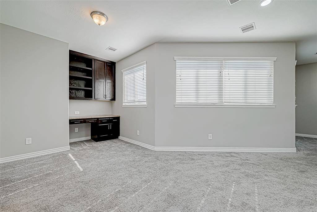 Serene room with a stylish desk and a sunlit window, ideal for your home office or creative space.