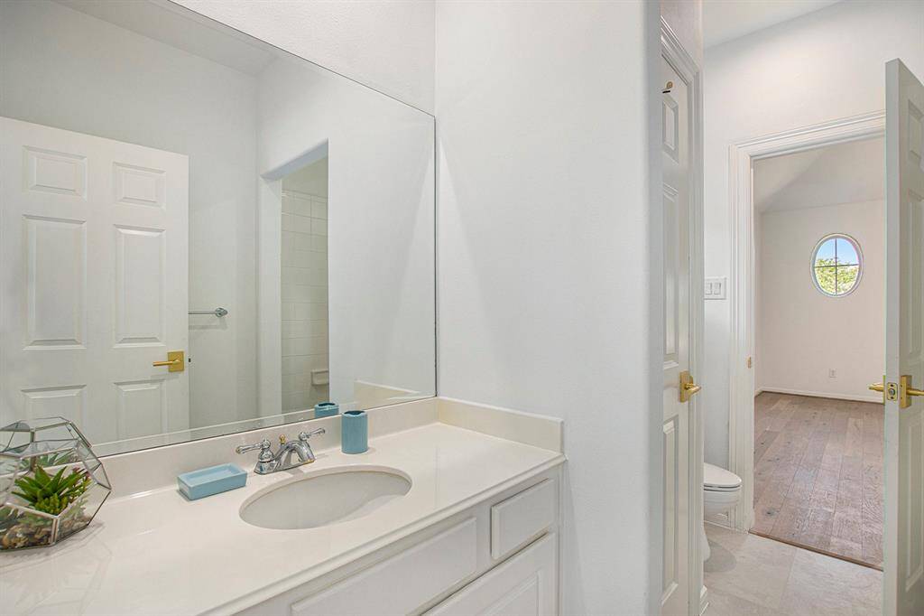 This is the third full bath in the house, complete with single vanity and toilet.
