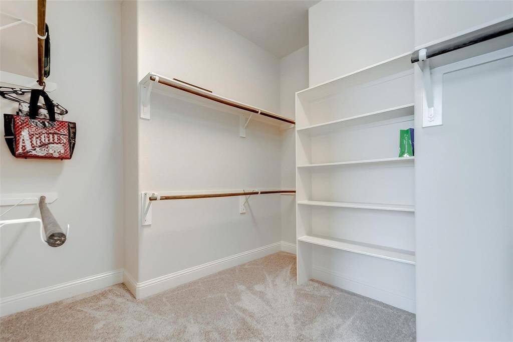 Large walk-in closet with plenty of built-in storage.