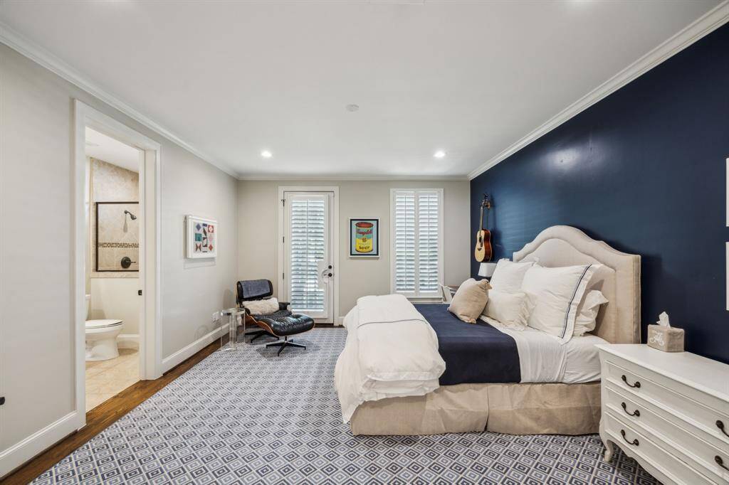 Measuring 16’7” x 14’2”, this beautifully updated bedroom features 2021 paint, rich 4” Red Oak hardwood flooring, and elegant crown molding. An 18-light French door with plantation wood shutters opens to a private terrace, filling the space with natural light. The room includes a generous 5’10” x 5’1” walk-in closet with built-in drawers, shelving, hanging racks, and a dome light for added convenience.