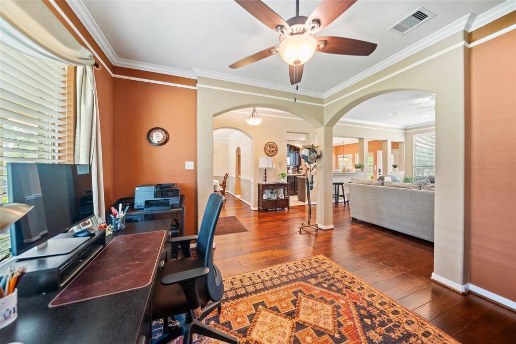 Another angle reveals arched openings and smooth flow from the office into the kitchen and living areas—an ideal layout for multi-purpose use.