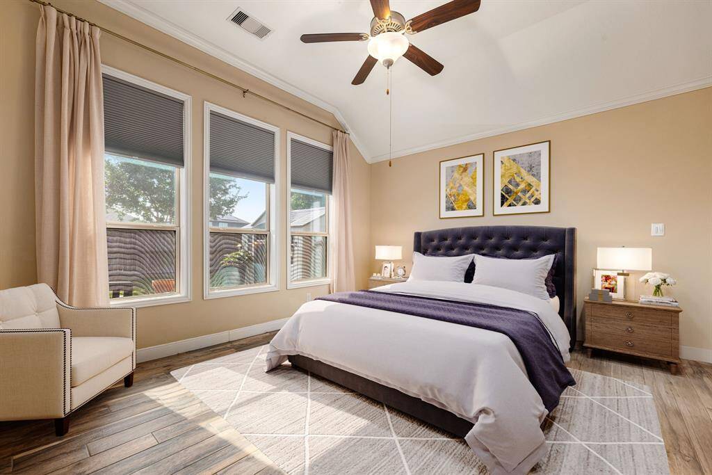 What a wonderful place to come home to! This stunning primary suite greets you with gorgeous wood like floors, a warm custom paint, high ceiling, crown molding, ceiling fan with lighting, large lovely windows with blinds allowing in natural light brightening up this spacious primary bedroom with extra space for a seating area. *virtual staging*