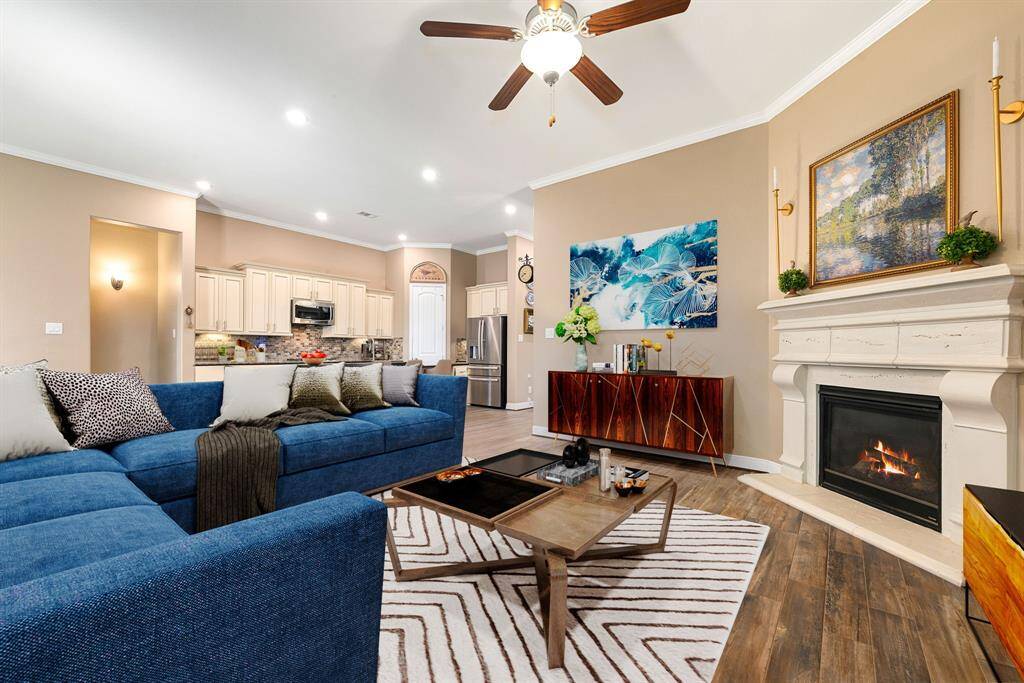 Gather the family and guests together in your lovely living room! Featuring crown molding, dark stained ceiling fan, custom paint, gorgeous wood like floors and large windows that provide plenty of natural lighting throughout the day. *virtual staging*