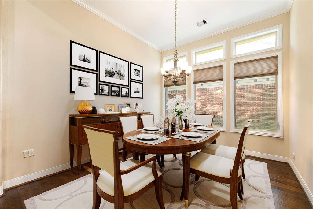 You and your guests will certainly dine in style in this amazing formal dining room! Featuring a gorgeous chandelier, large window with blinds, custom neutral paint, high ceilings, crown molding and wood like flooring. Perfect space to entertain family and friends. *virtual staging*