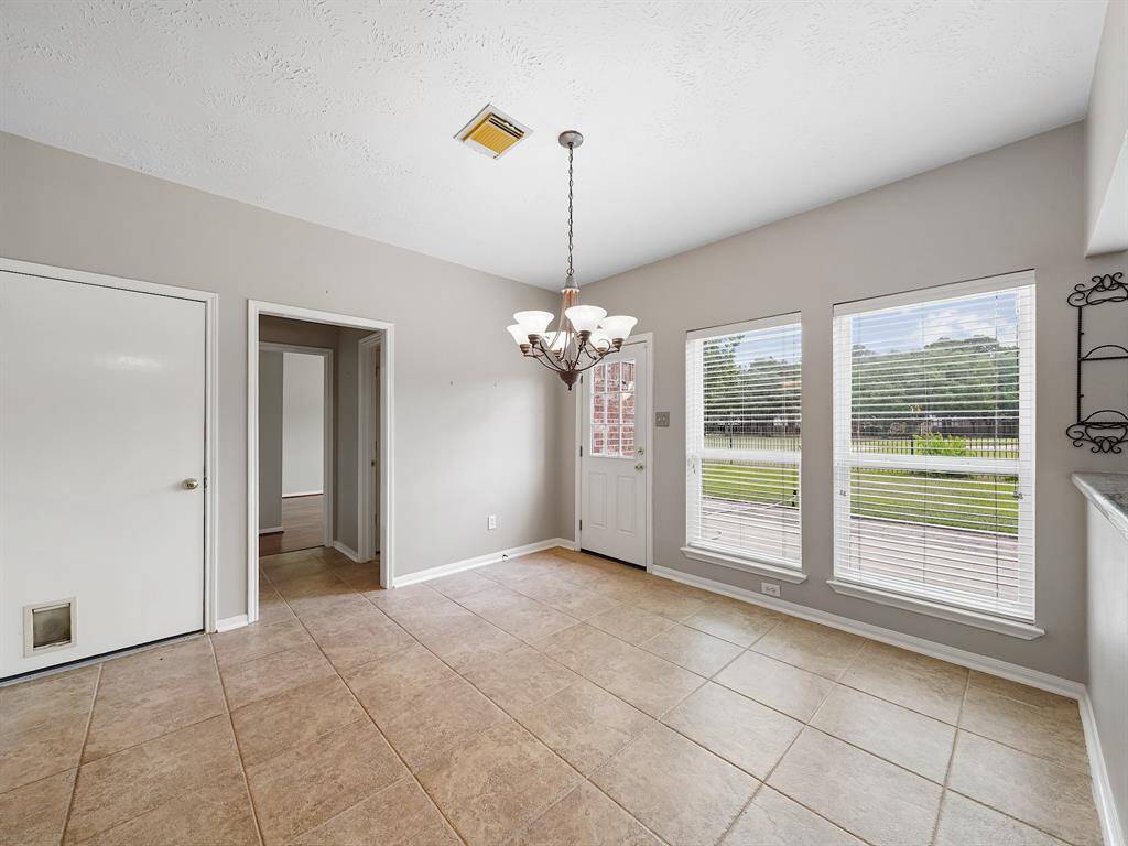 Enjoy meals in the spacious breakfast room. Access to the backyard through the door to the left of the windows.