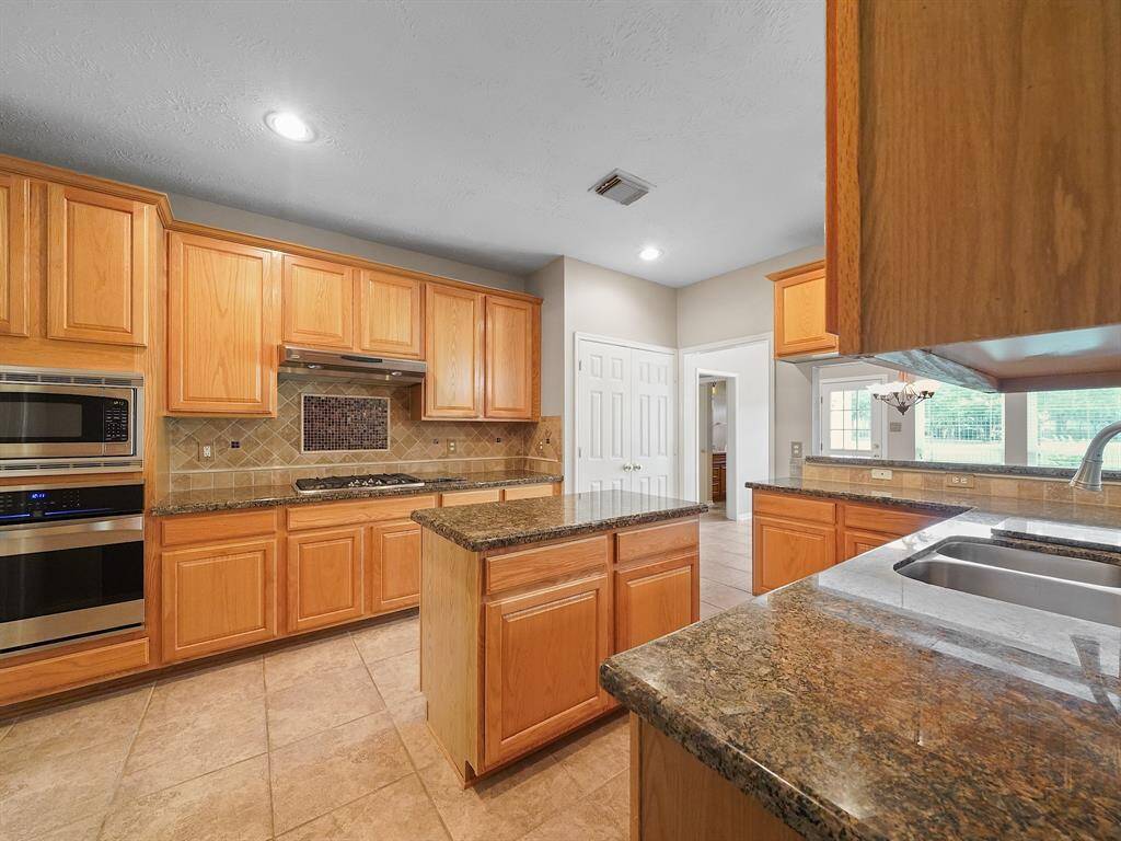 Gas cooktop and stacked microwave and oven for the chef in the family.