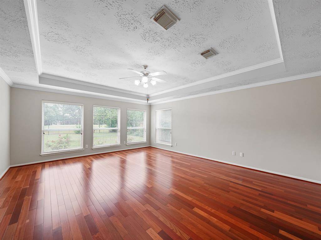 Primary bedroom with plenty of space for oversized furniture and views of the backyard.