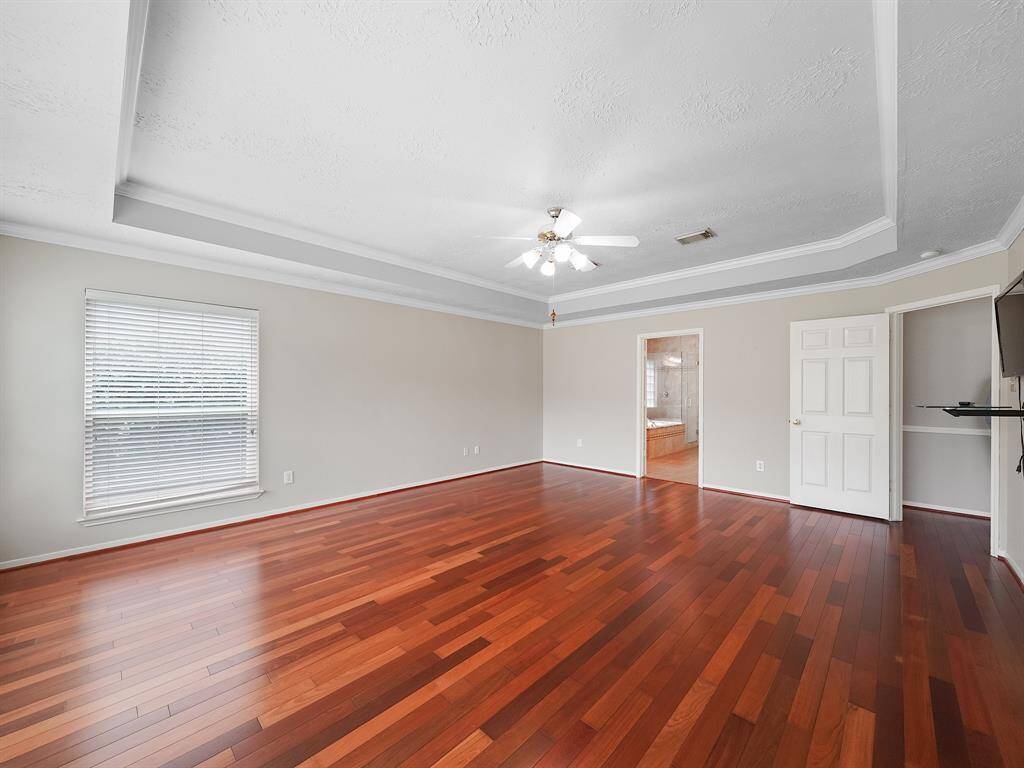 The primary bedroom is located just off the kitchen/breakfast area. Features an en suite bath.