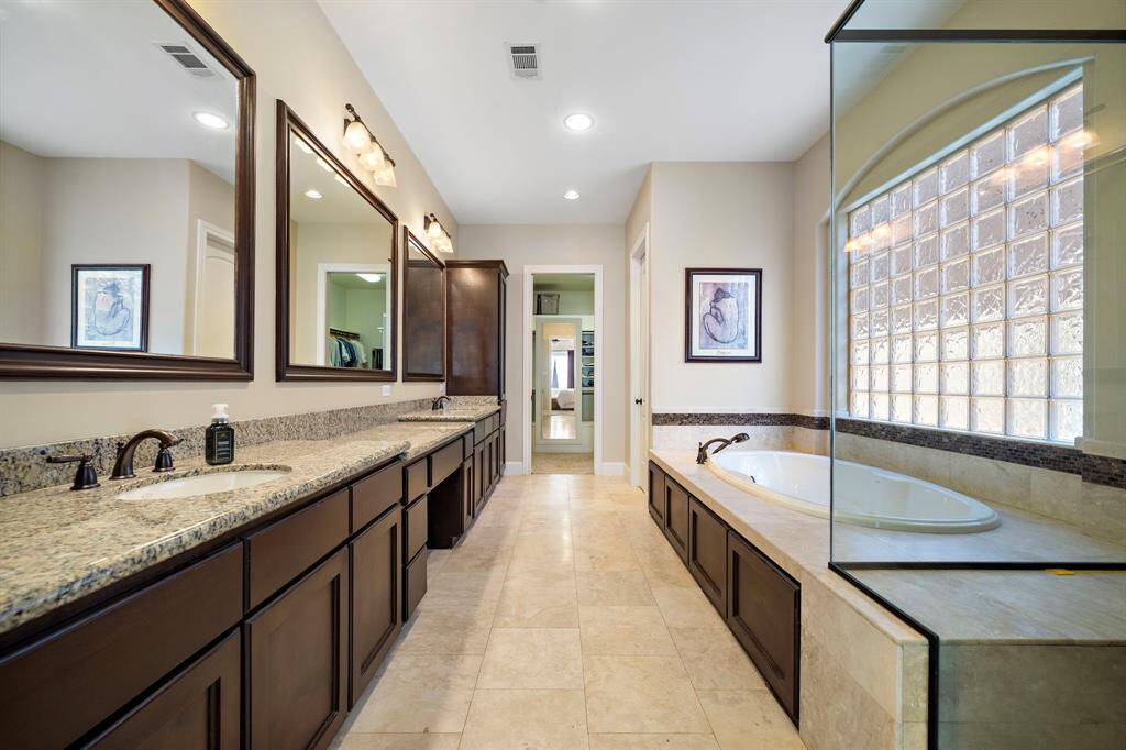 Large master bath with double sinks as well as separate bath and shower