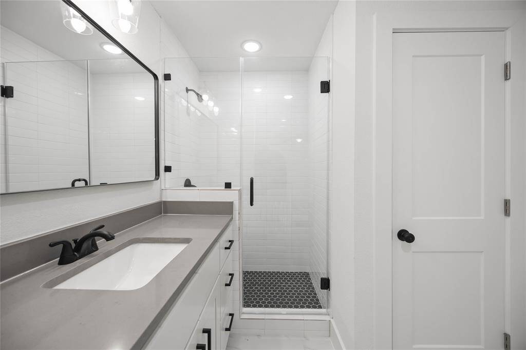 Glassed enclosed shower in the primary bathroom.