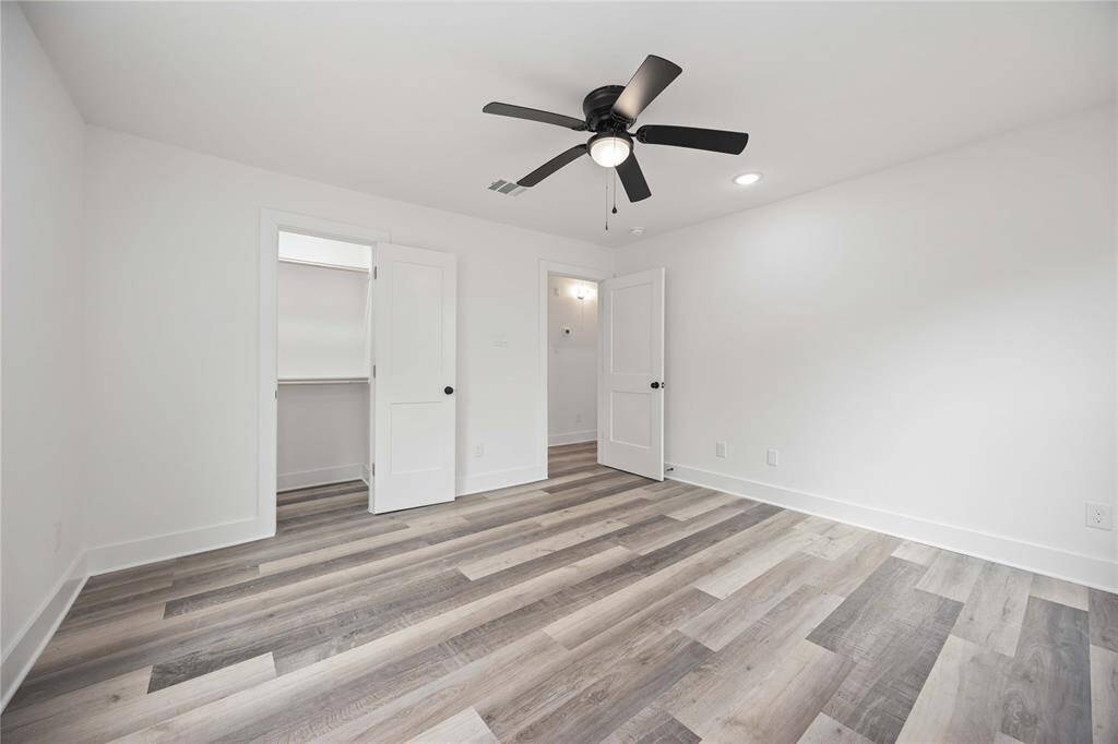 The walls are painted white in the secondary bedroom, offering a clean canvas for personalization.