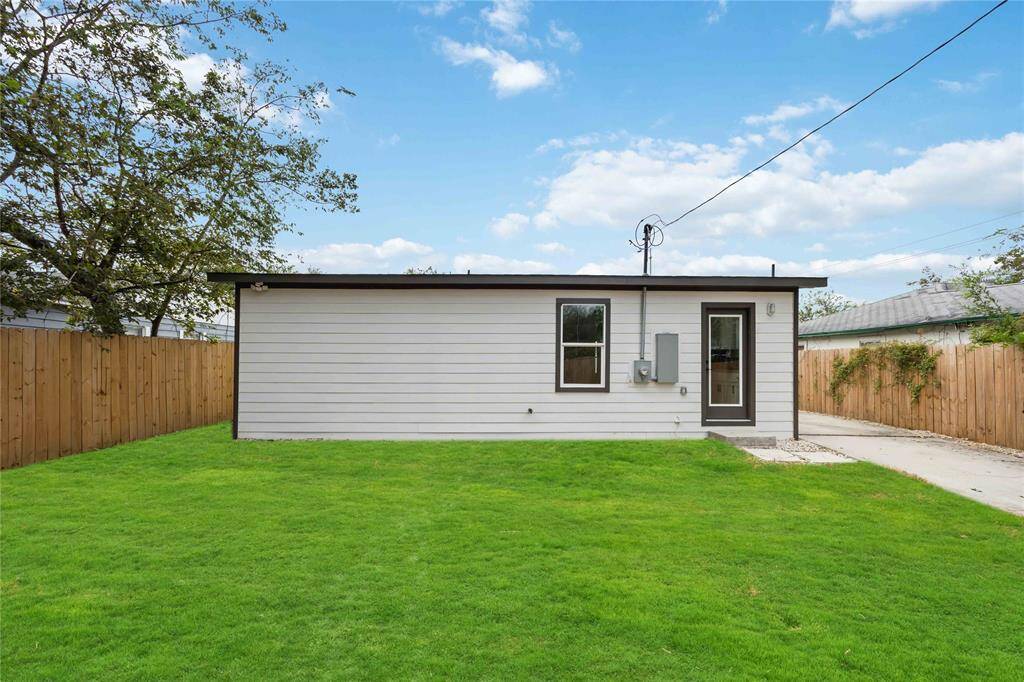 Enjoy privacy and ample outdoor space with a tasteful wooden fence surrounding a generous backyard.
