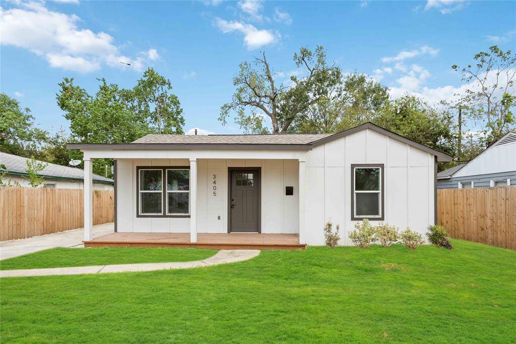 Discover your charming new bungalow, featuring an inviting porch and vibrant green surroundings.