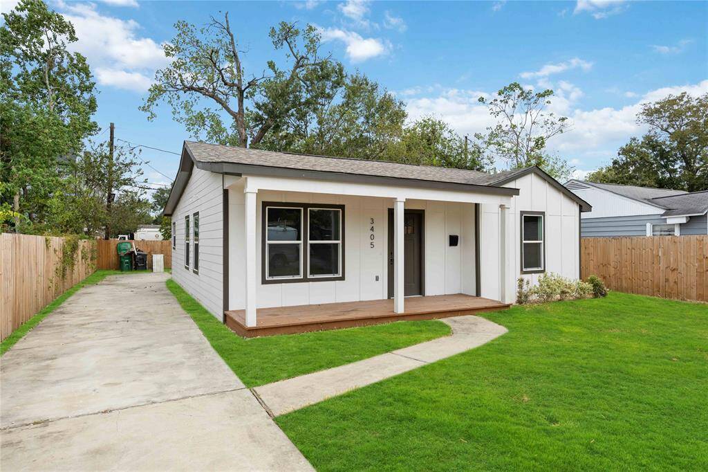 This is a cozy, single-story home featuring fresh landscaping, a long driveway, and a privately fenced backyard.