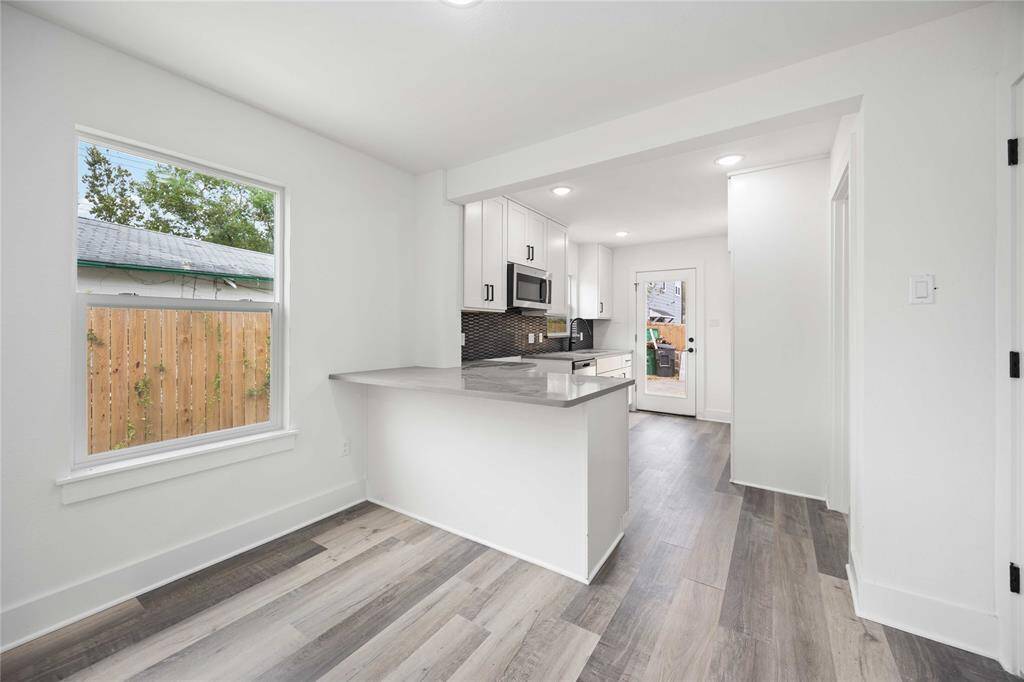 Up-to-date kitchen featuring a gorgeous island with seating bar.