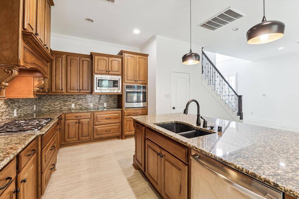 Chef’s dream kitchen—bold granite, rich cabinetry, and sleek finishes that wow!