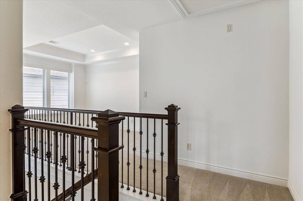 Upstairs landing opens to a bright, versatile den—perfect for a lounge, library, or home office.
