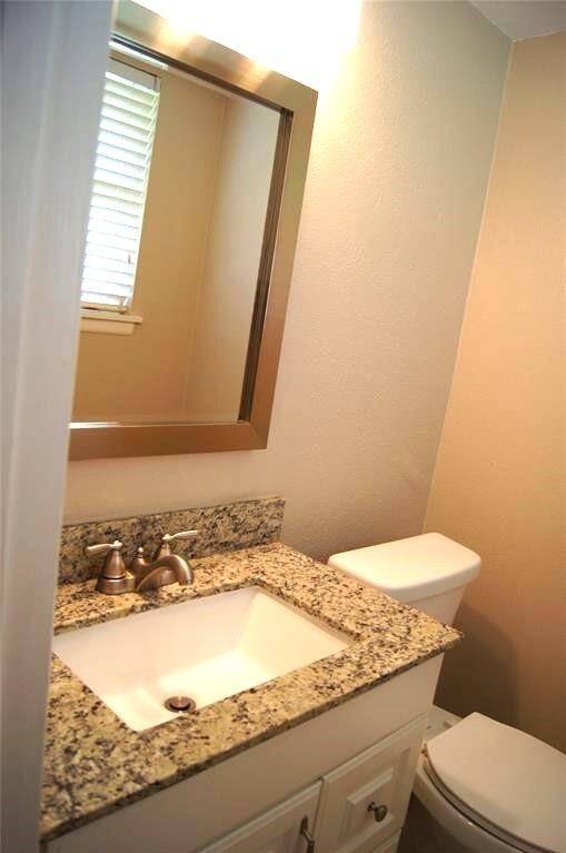 PRIMARY HALF BATHROOM WITH GRANITE COUNTER TOP