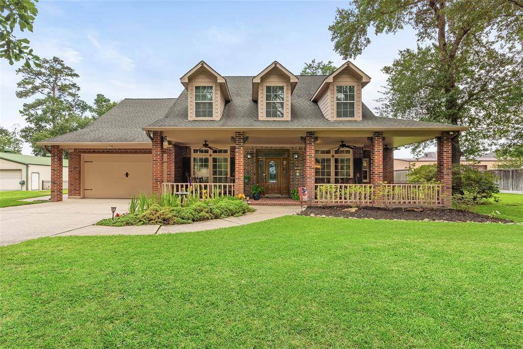 Charming home features a classic brick exterior with a welcoming front porch and dormer windows. It offers a spacious driveway leading to a two-car garage, and a neatly landscaped front yard with mature trees. Ideal for those seeking a cozy yet elegant setting.