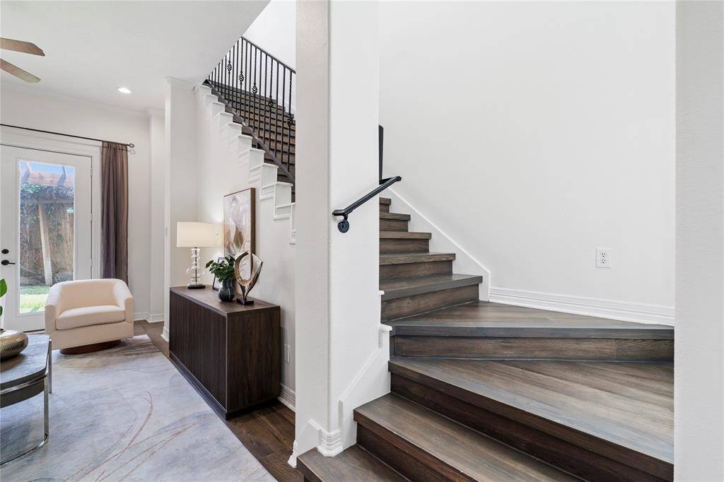 Wood-accented stairwell with clean lines leads to private living quarters upstairs.