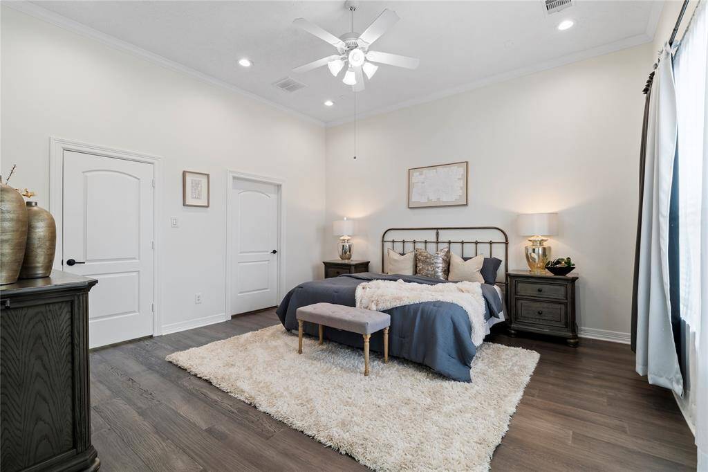 Generous proportions define this inviting primary bedroom, ideal for relaxation.