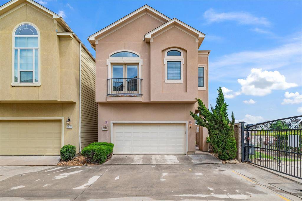 Timeless stucco facade blends traditional charm with a modern, gated community feel.