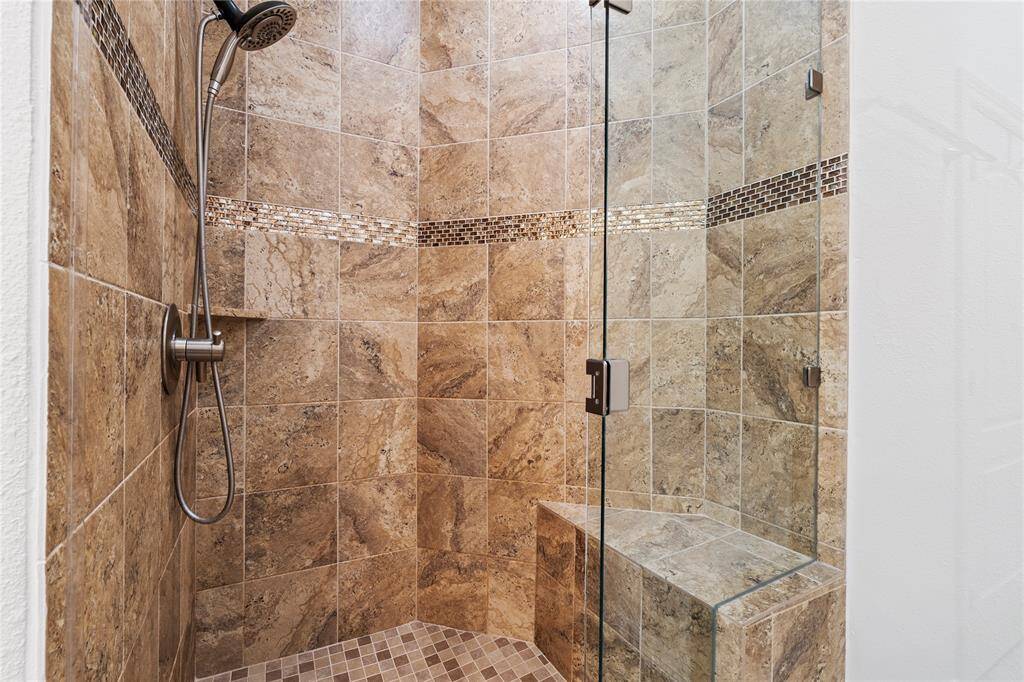 The ensuite bath offers both function and indulgence with separate tub and walk-in shower.