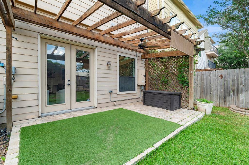French doors open to a covered patio and fully fenced backyard—ideal for entertaining or quiet evenings.