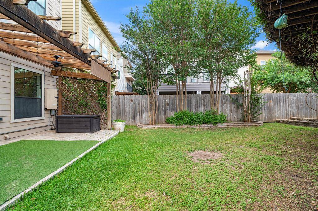 A tranquil escape in the heart of the city, complete with green space and privacy fencing.
