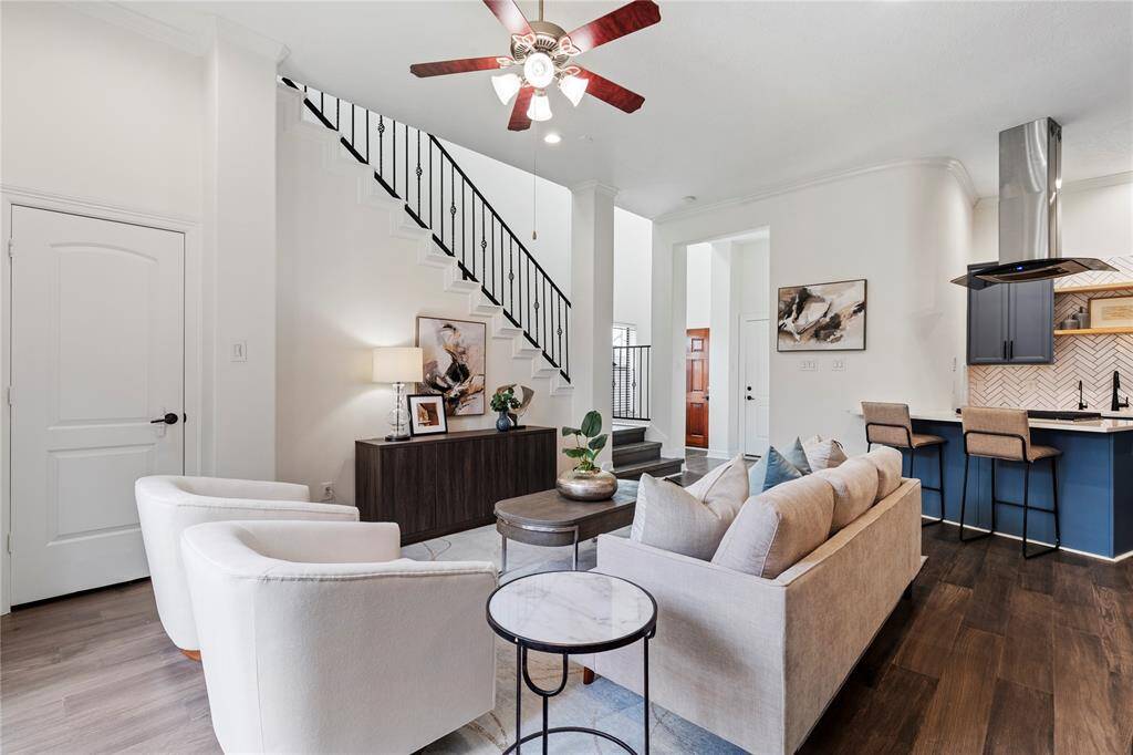 Expansive first-floor living space with soaring ceilings and wide plank engineered wood floors.