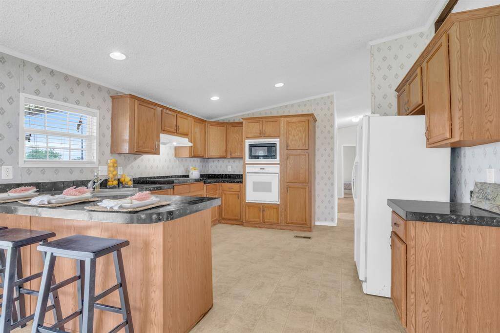 Kitchen Area with a Breakfast Bar for those Quick Meals! 37038 Bell Rd.,Waller, TX 77484