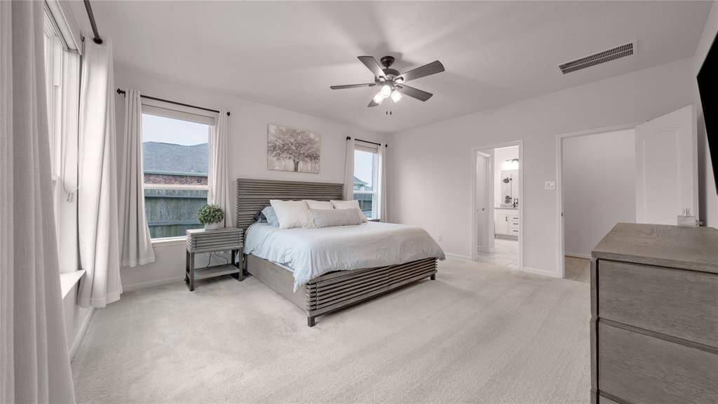 The primary bedroom, located off the family room, has great natural light.