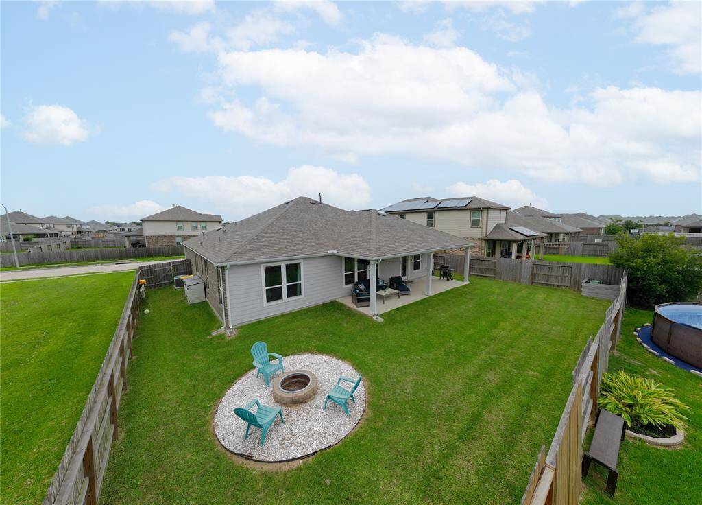 Backyard has a fire pit space and plenty of room to run.