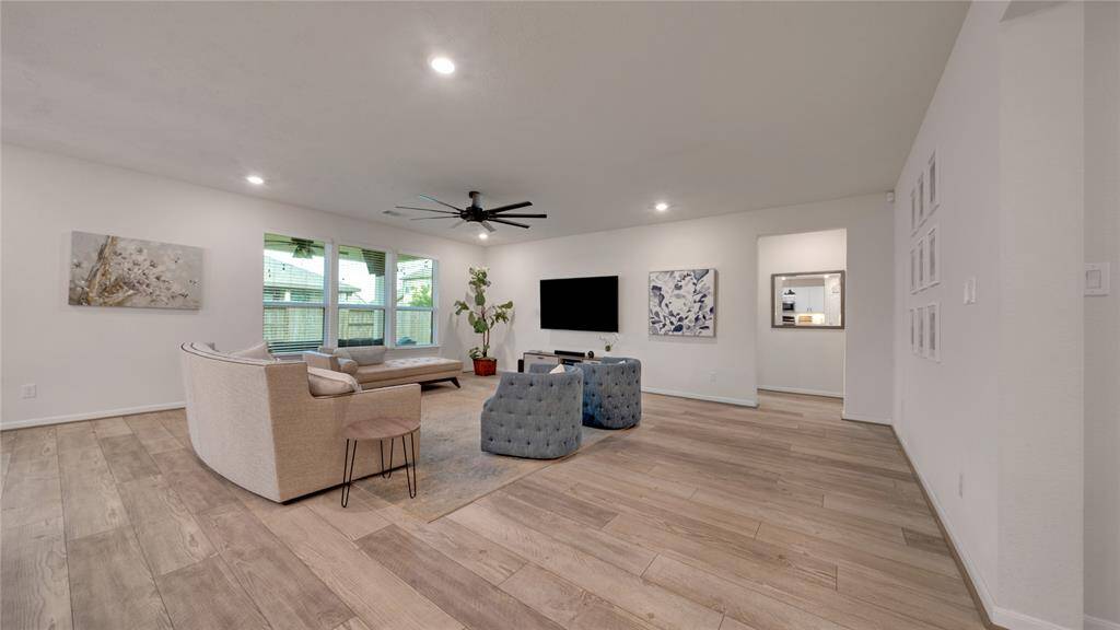 The entry way leads past the secondary bedrooms into the open concept family/kitchen/dining areas.