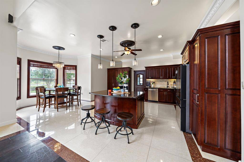 The kitchen has a center island and a large breakfast nook by the back door.