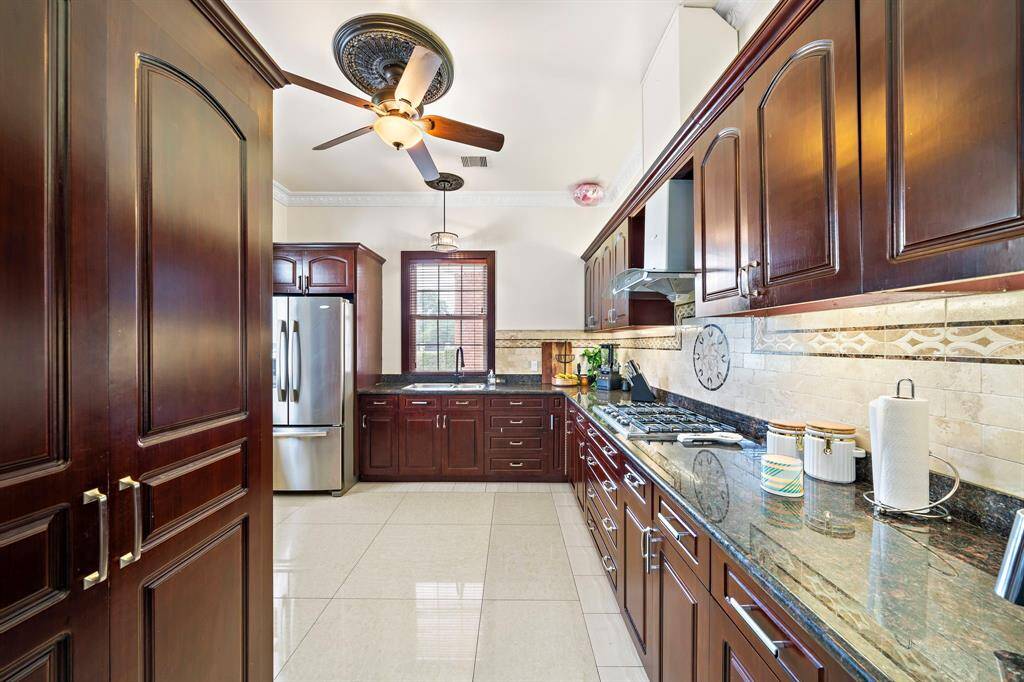 The back kitchen for caterers or just a second area to prepare a feast and make a mess. The door closes and no one can see it. It includes a second refrigerator and a huge pantry area.