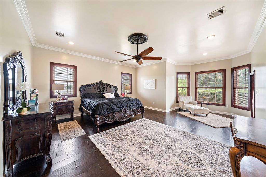 The primary suite is located just off the living room. Room for large furniture and a sitting area.