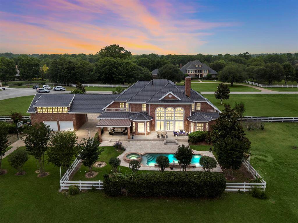 The back of the house has a gorgeous pool surrounded by multiple seating areas and decking. There is also a pond with a few turtle residing in it.